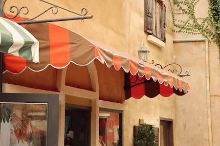 Restored storefront awning with bright colors on magazine street